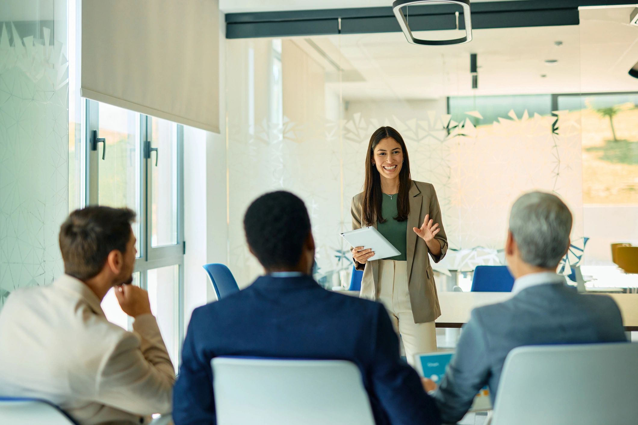 Businesswoman presenting procurement recommendations to a team