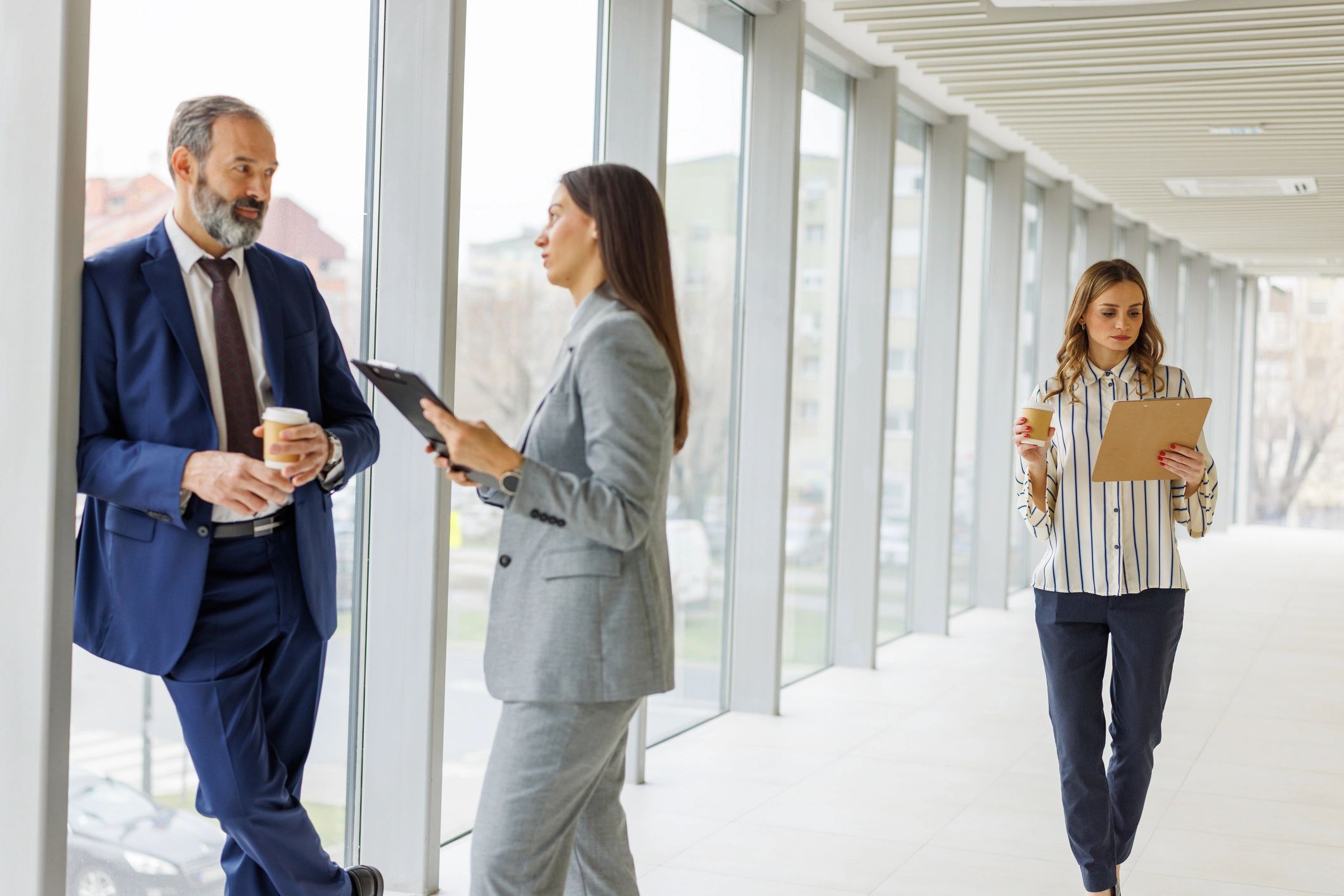 Business professionals collaborating in a corporate hallway